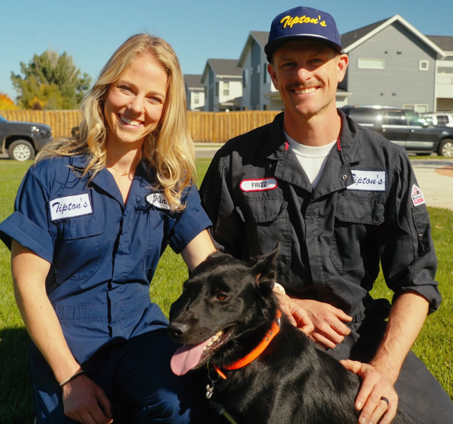 Erik, Kinsey, and Tipton sitting together outside in their Tipton’s Tires uniforms in Bozeman, Montana.